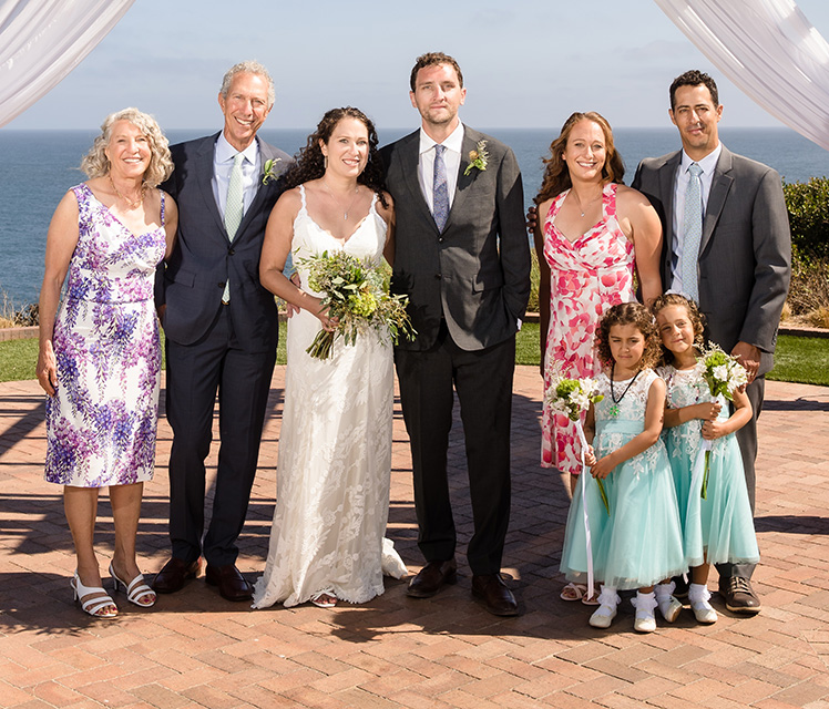 Barbara and Rick Levy (far left) celebrate their daughter's wedding in July, with their family (including their daughters, sons-in law and two granddaughters).