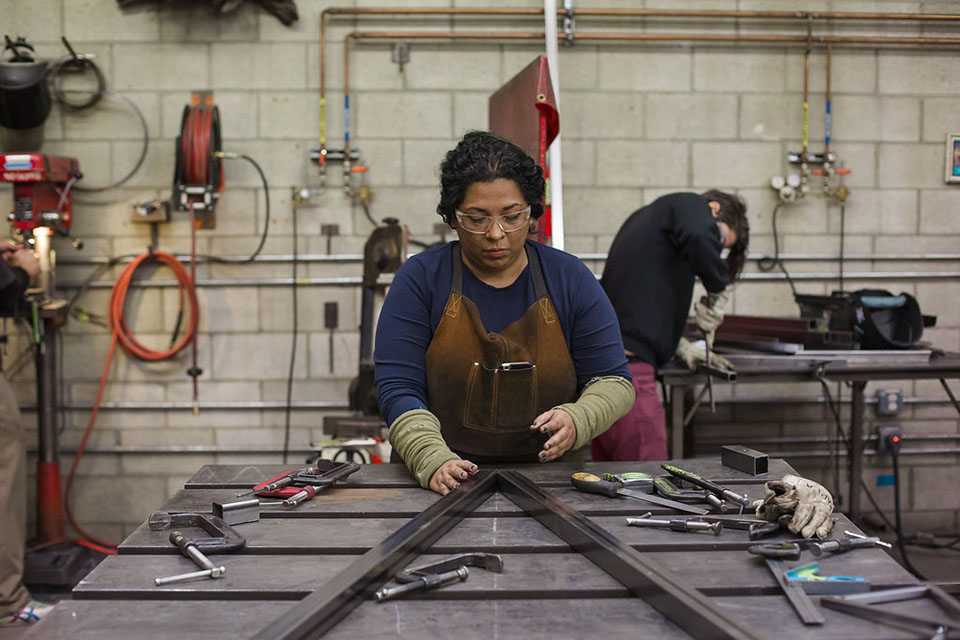 Beatriz Cortez works an art piece called the Tzolk'in. Photo courtesy: Gina Clyne and Clockshop.