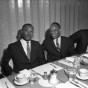 Martin Luther King, Jr. sits with two men at dining table.