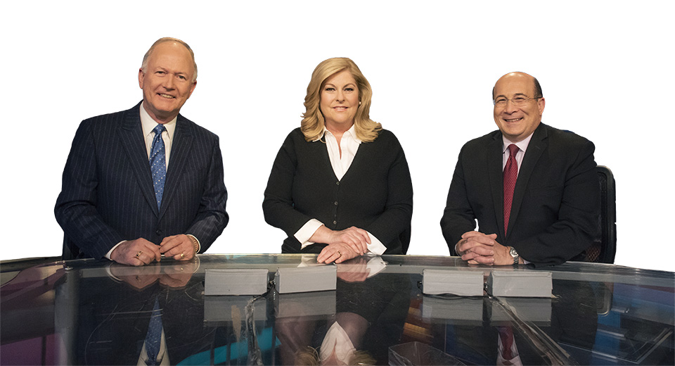 Alumni Bill Griffeth, Sue Herera and Ron Insana at their television anchor desk in CNBC's New Jersey studio.