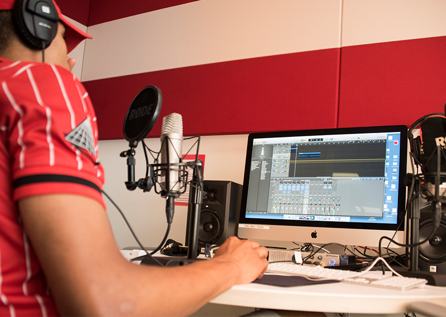 A student produces an audio track in the Creative Media Studio's recording studio.