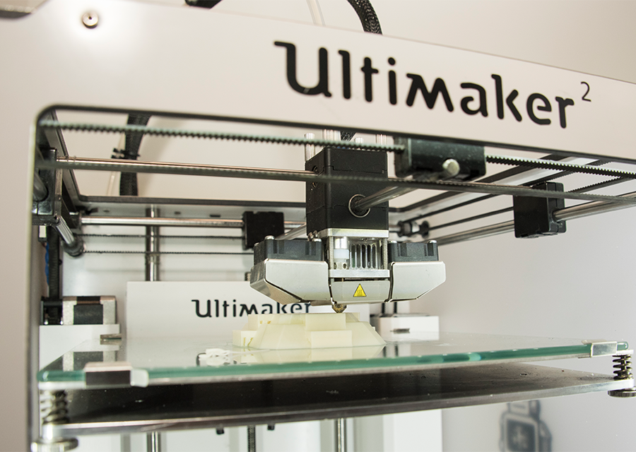 An Ultimaker 3-D printer builds a 3-D figure out of a digital design.
