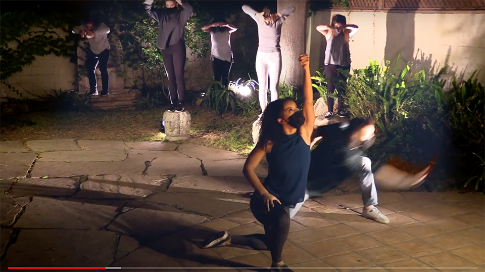 Masked CSUN dancers perform at night in their film "Lux Aeterna."