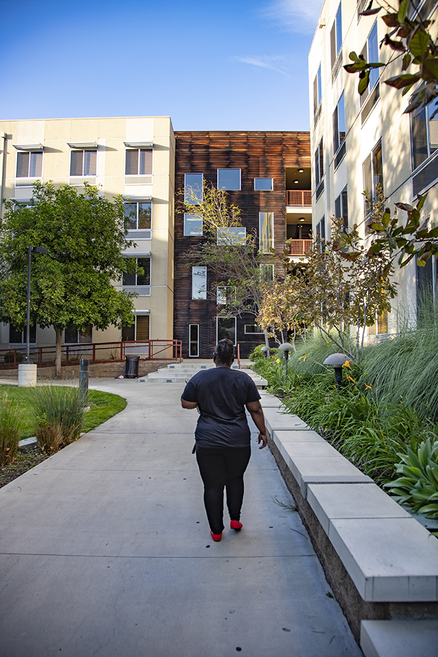 CSUN student Tracey Spann walks through the Student Housing area.