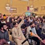 CSUN Muslim Student Association members raising their hands at a mosque.