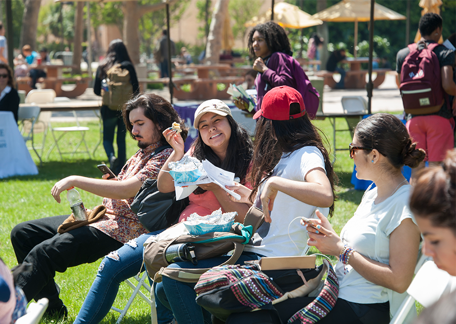 CSUN students enjoy free tacos at the Campus Store Complex lawn during the Cesar Chavez Service Fair in 2017.