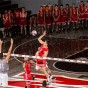 CSUN's Eric Chance spikes a volleyball over the outstretched hands of an opponent at the net.