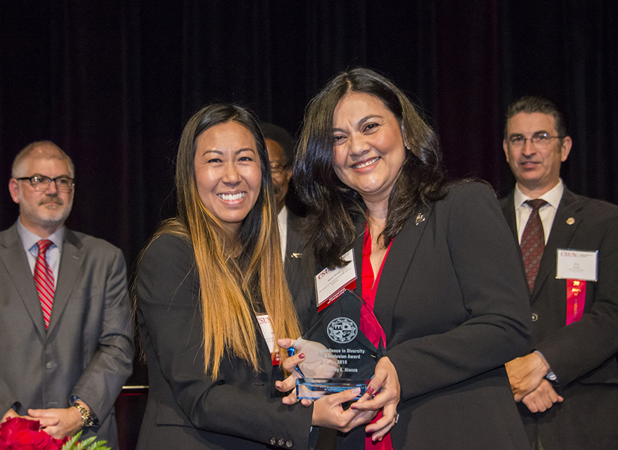 Susan Hua poses with Nancy Alonzo, holding CSUN's Excellence in Diversity & Inclusion Award.