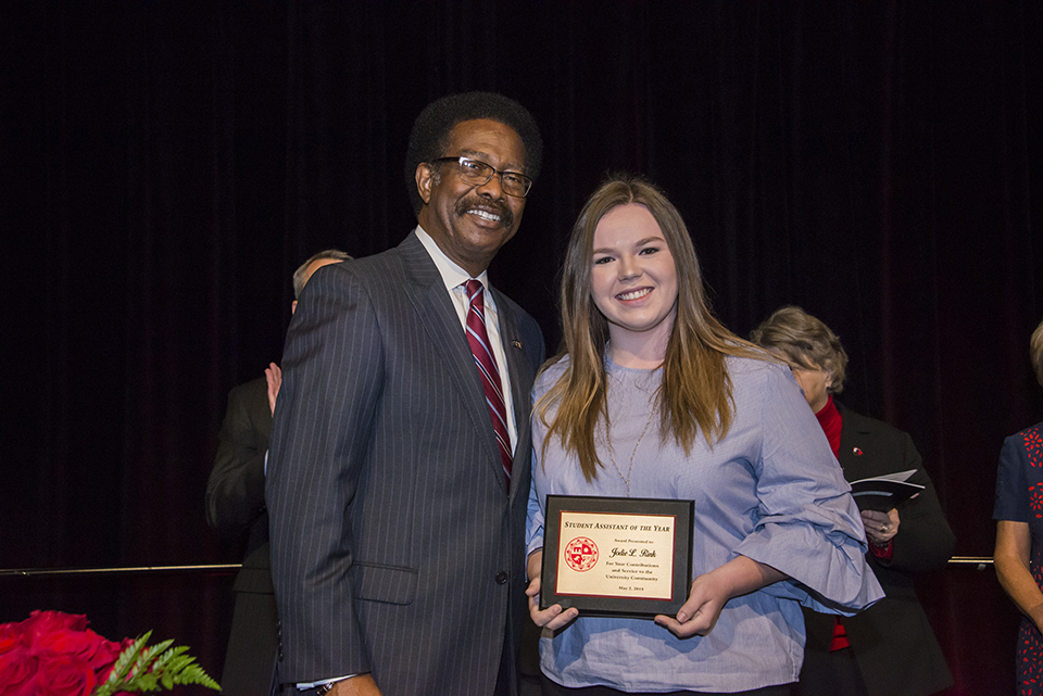 William Watkins poses with Jodie Rink, who holds her Student Assistant of the Year award.