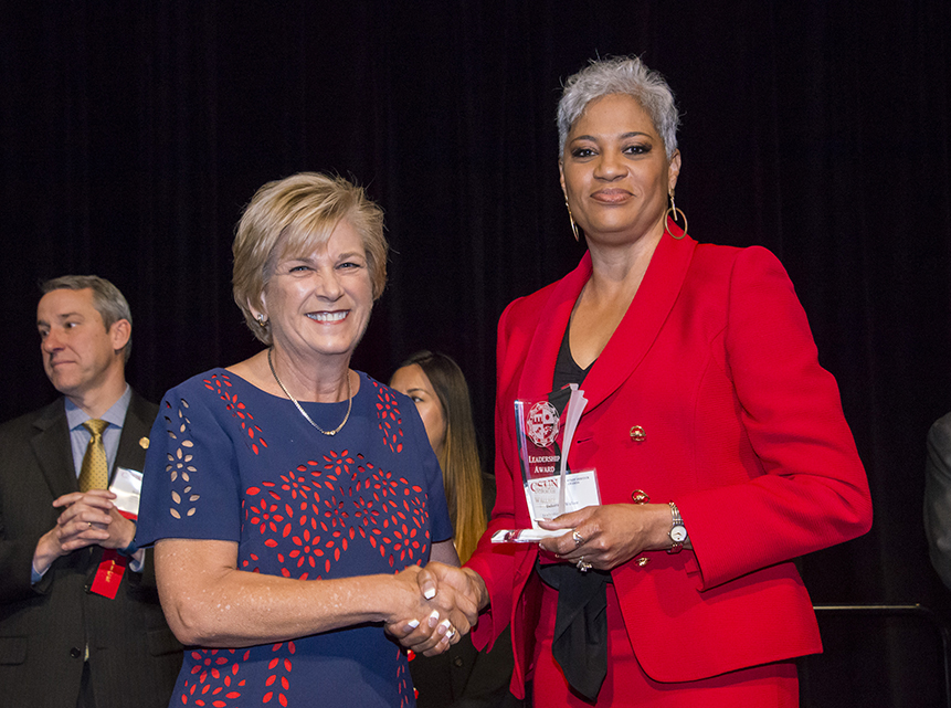 Hilary J. Baker shakes Deborah Wallace's hand after Wallace receives CSUN's 2018 Leadership Award.