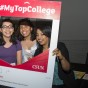 Three students pose with #MyTopCollege photo cut-out.