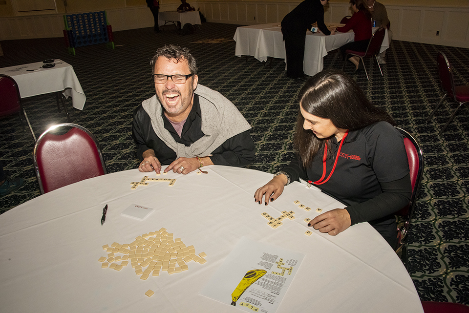 A male CSUN faculty member laughs while seated next to a female colleague during the 2020 Faculty Retreat.
