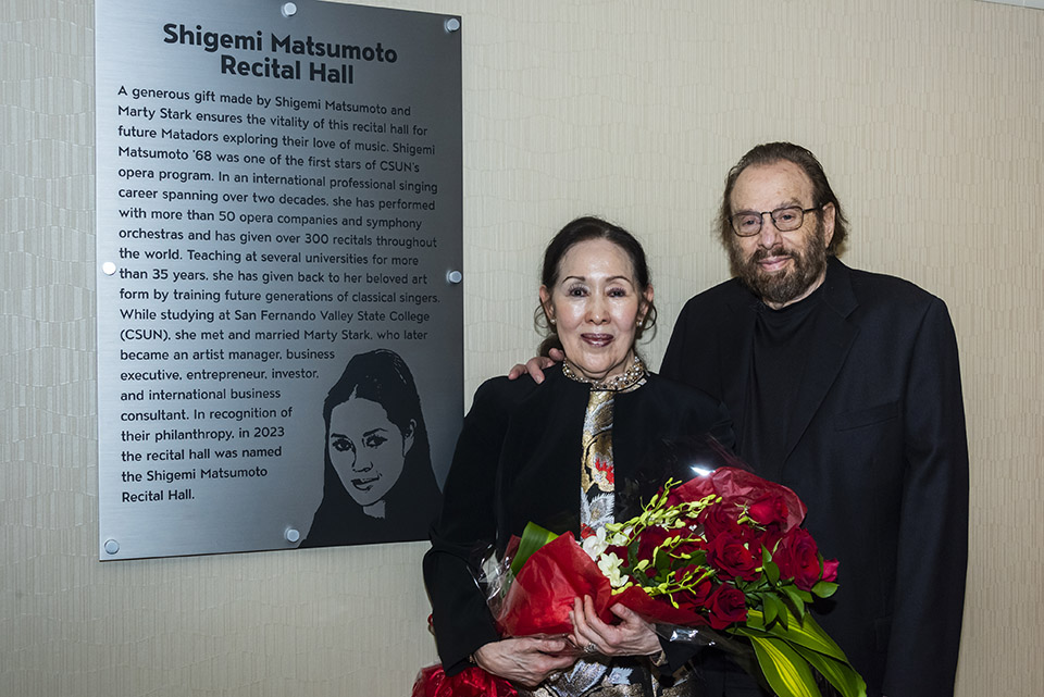 Shigemi Matsumoto '68 and her husband, Marty Stark, stand by the plaque commemorating their contributions to the newly named Shigemi Matsumoto Recital Hall at CSUN.