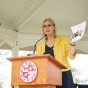 CSUN President Dianne F. Harrison speaks at a podium with a CSUN seal.