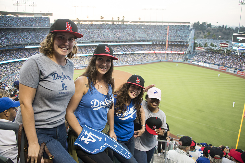 Four friends pose in the stands at Dodger Stadium.