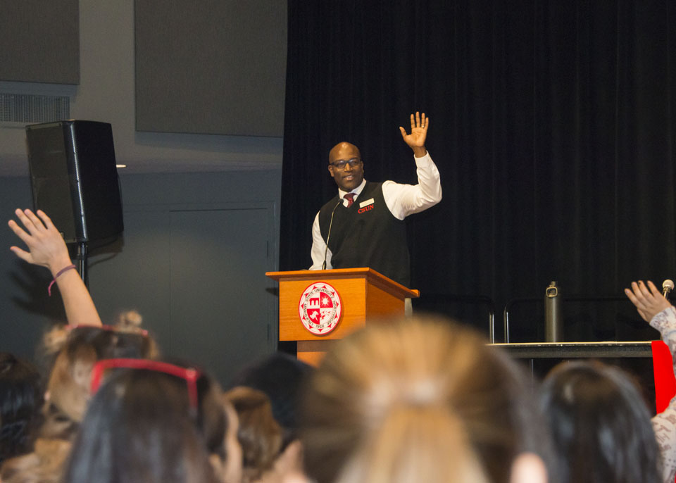 Students raise their hands to ask questions about CSUN financial aid forms.