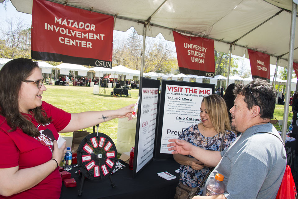 Family asks the Matador Involvement Center representative questions in the Expo at the Sierra Quad.
