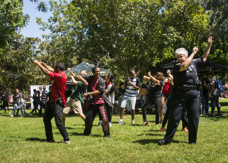 Students and CSUN police chief dancing on Bayramian Lawn.
