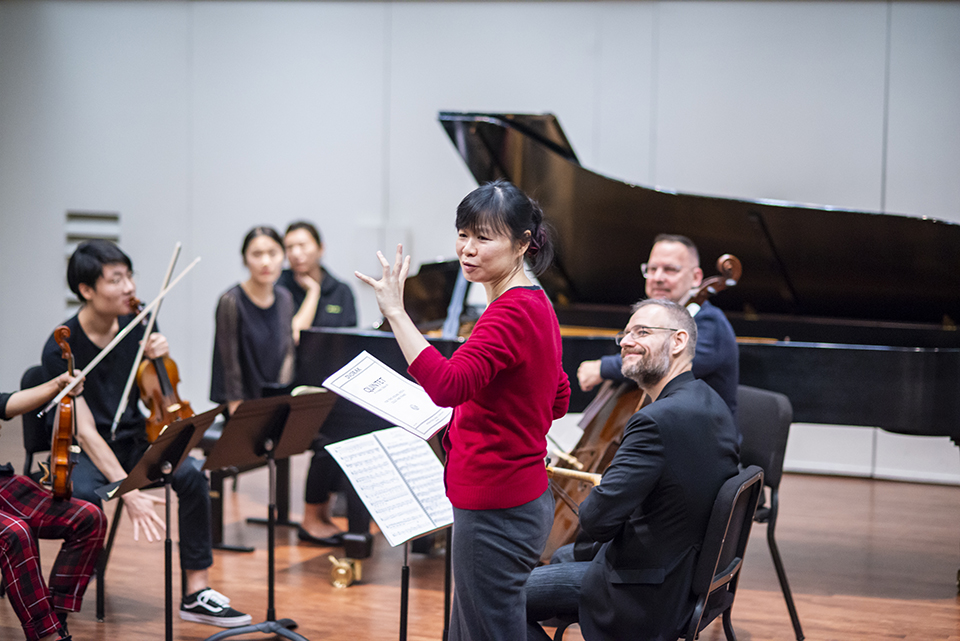 Violinist Bin Huang, surrounded by musicians while teaching a master class at CSUN.