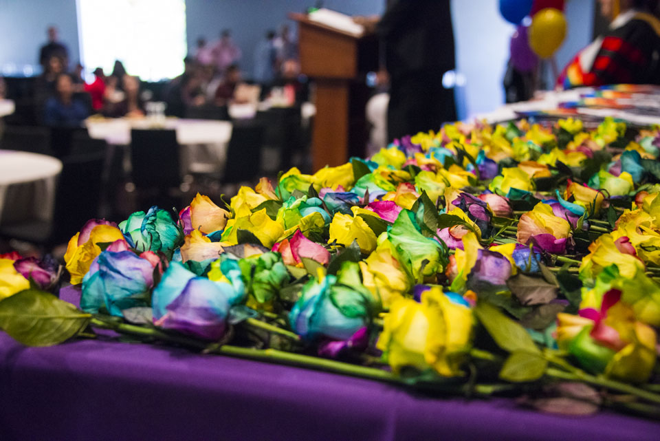 A table full of rainbow flowers that students received during graduation.
