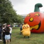 Pikachu stands in front of inflated pumpkin