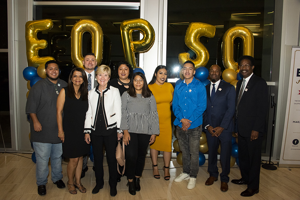 A large group of Matadors stand in front of an EOP 50 balloon display.