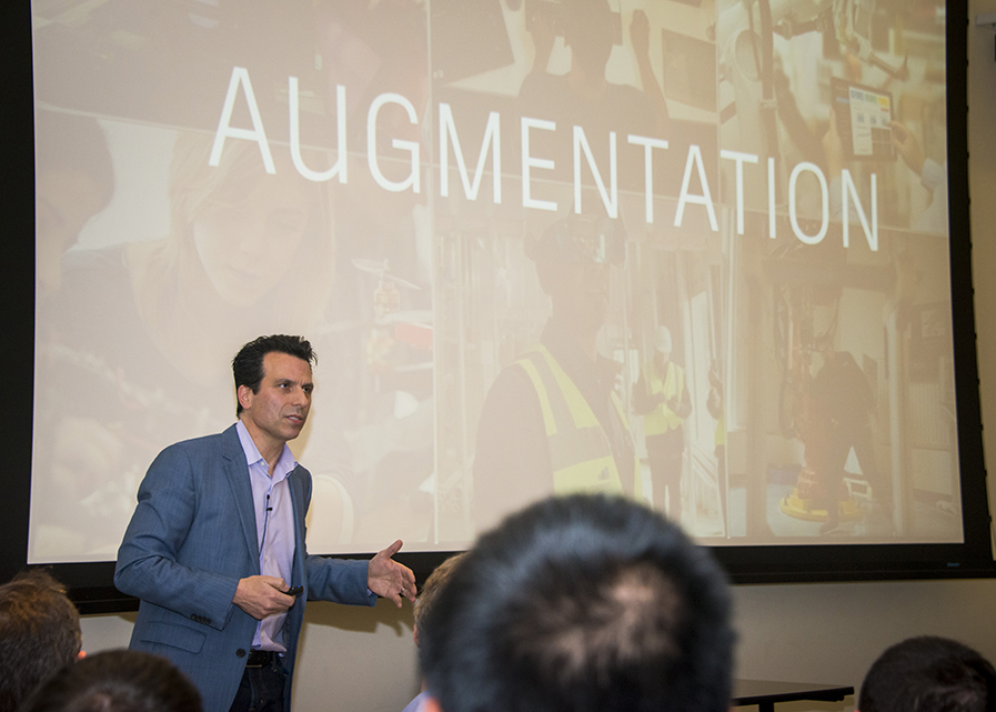 Andrew Anagnost stands in front of a screen that says 