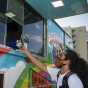 Student is handed frozen treat through the window of colorful truck.