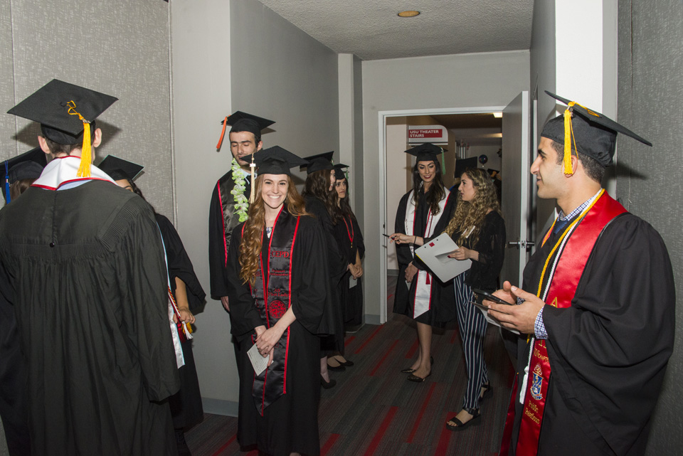Graduating students entering a room