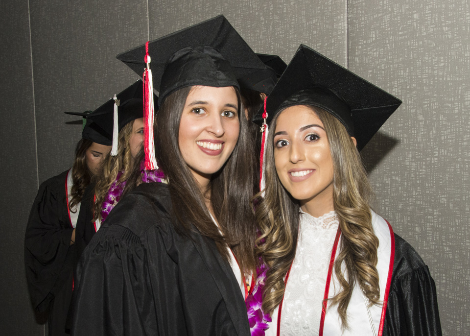 Two smiling graduating girls in cap and gown