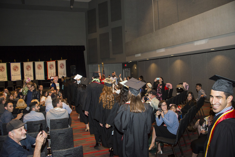 Graduates walking down aisle to stage