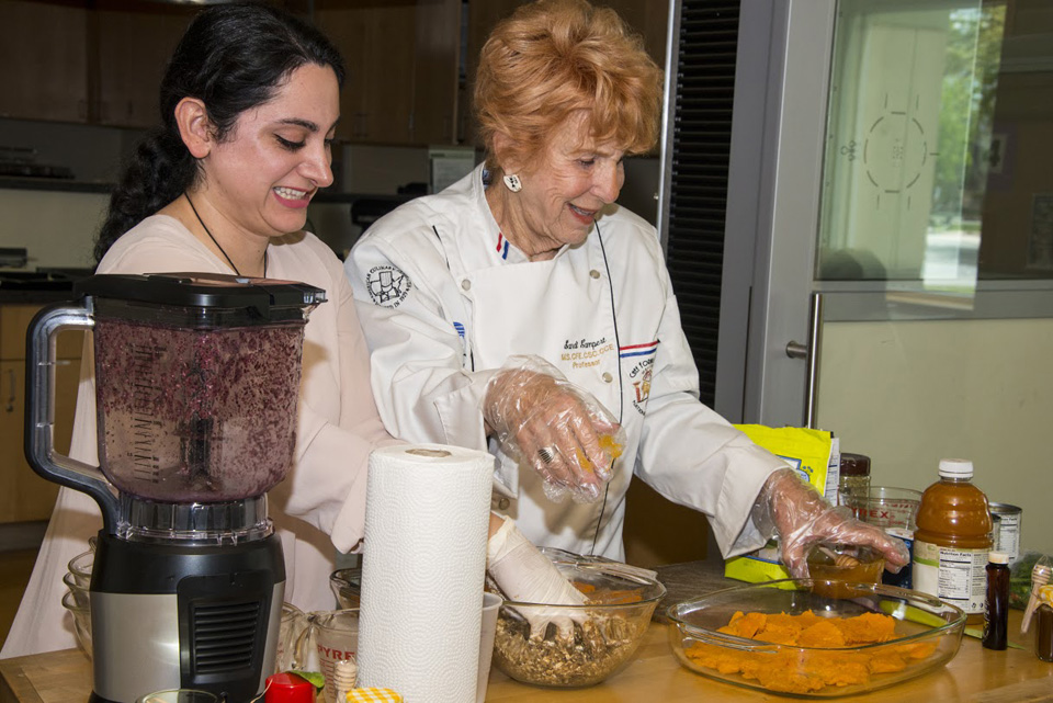 Sandi Lampert and Shelly Salemnia doing a food preparation for the audience at Cooking for Health.