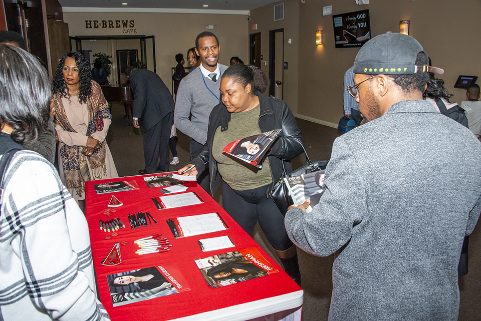 Churchgoers peruse information about CSUN at H.O.P.E.’s House Christian Ministries.