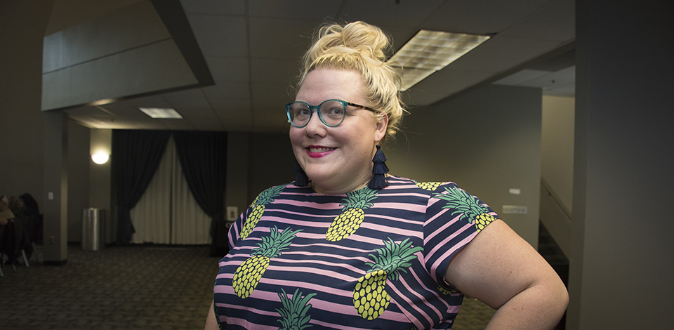 Lindy West wearing green glasses and a pineapple print dress