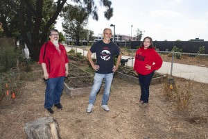 Jesus Alvarez, Professor Natale Zappia, and Mabel Trigueros are standing up smiling at the camera in the middle of CSUN's Institute for Sustainability Garden.