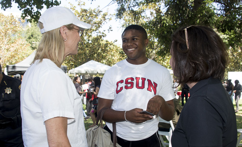President Dianne F. Harrison talking to a CSUN student.