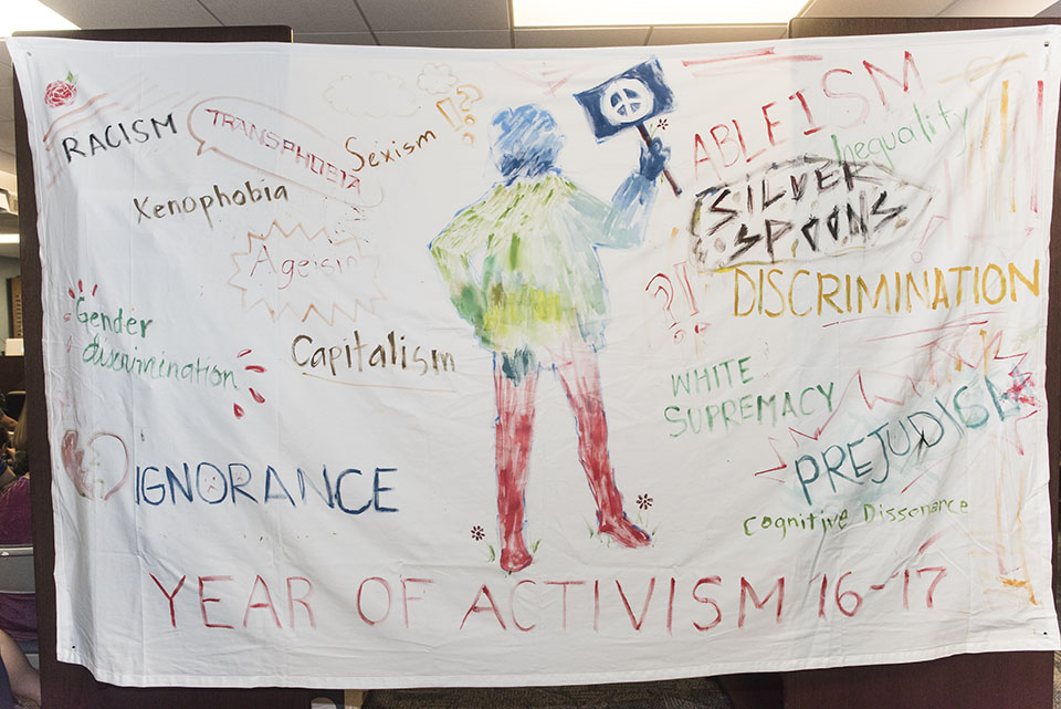 White sheet painted with words relating to activism.