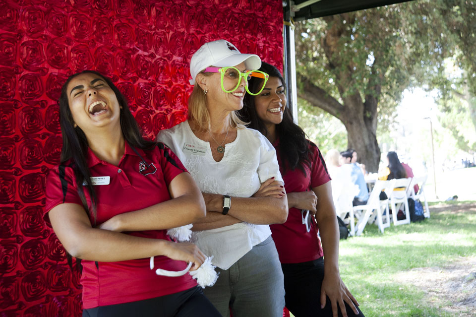 CSUN President Dianne F. Harrison taking a silly photo with students.