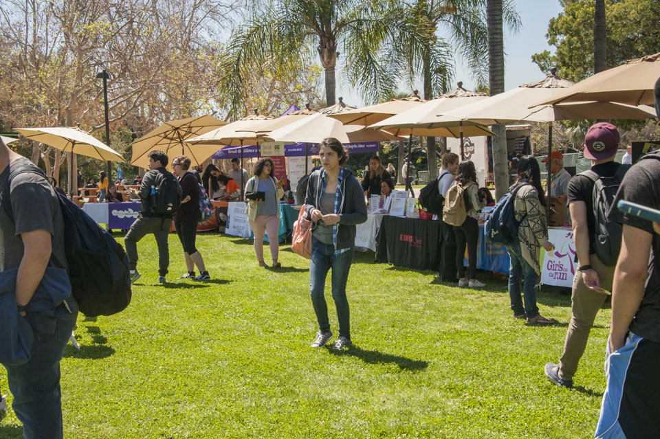 Event attendees and tables with tents at the Matador Bookstore lawn.