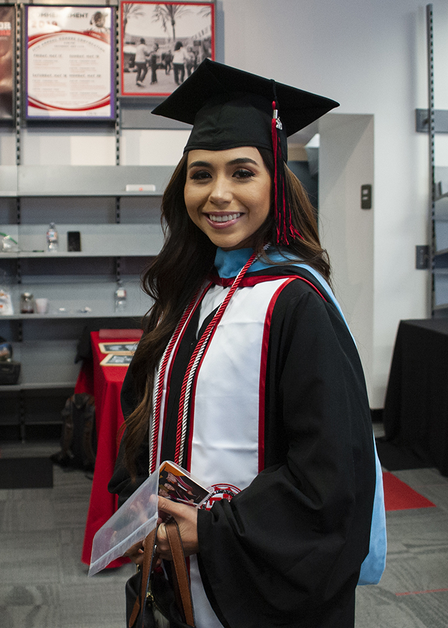 Young woman, in cap and gown,