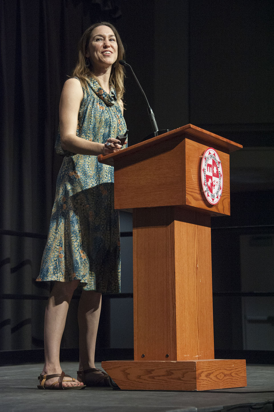 Clare Fox standing behind speaker podium.