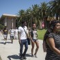 Students walk to class in pairs on a sunny first day of the semester.