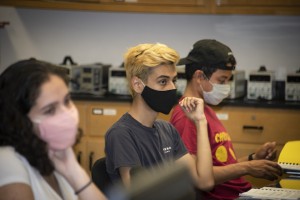 CSUN students sitting at a desk wearing masks. 