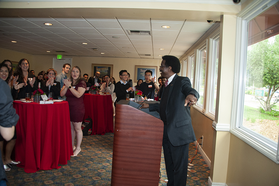 William Watkins, CSUN Vice President for Student Affairs, speaking to a room full of students at a formal reception.