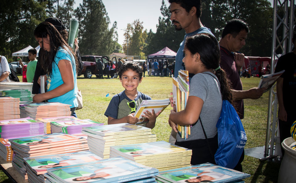 Youngster at book distribution table.