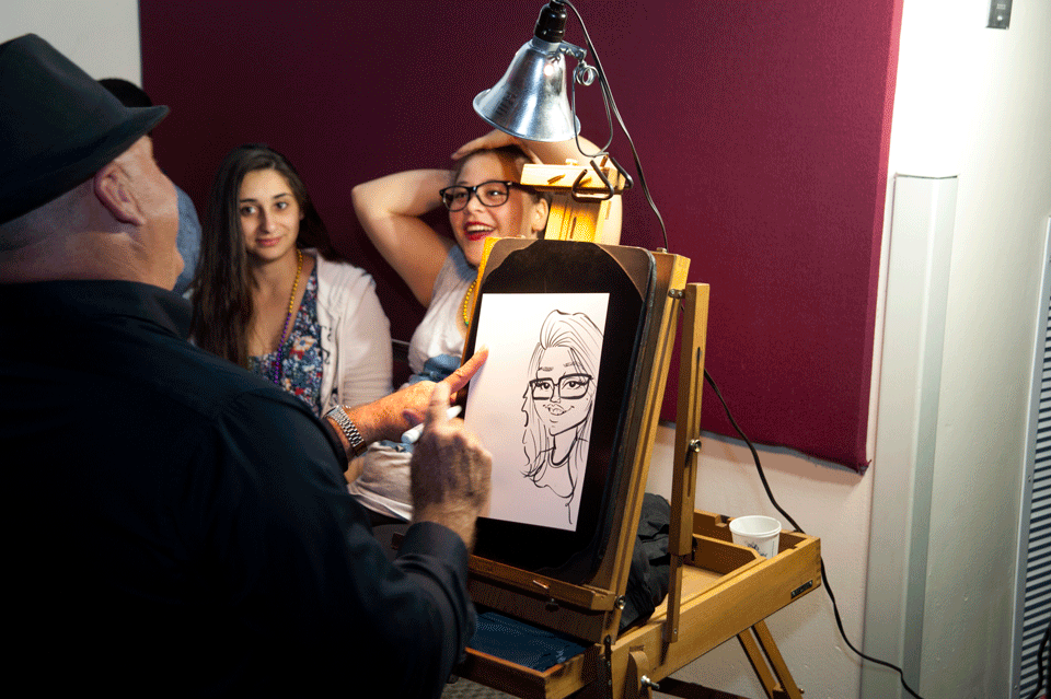 Caricature artist draws a female student