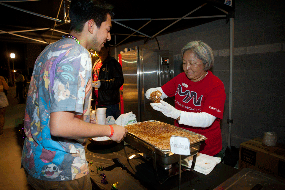Student gets a helping of jambalaya at a food stand