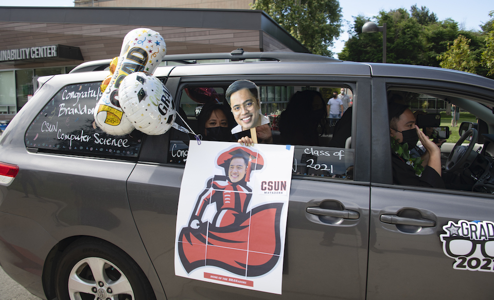 Van decorated with photos of the graduate.