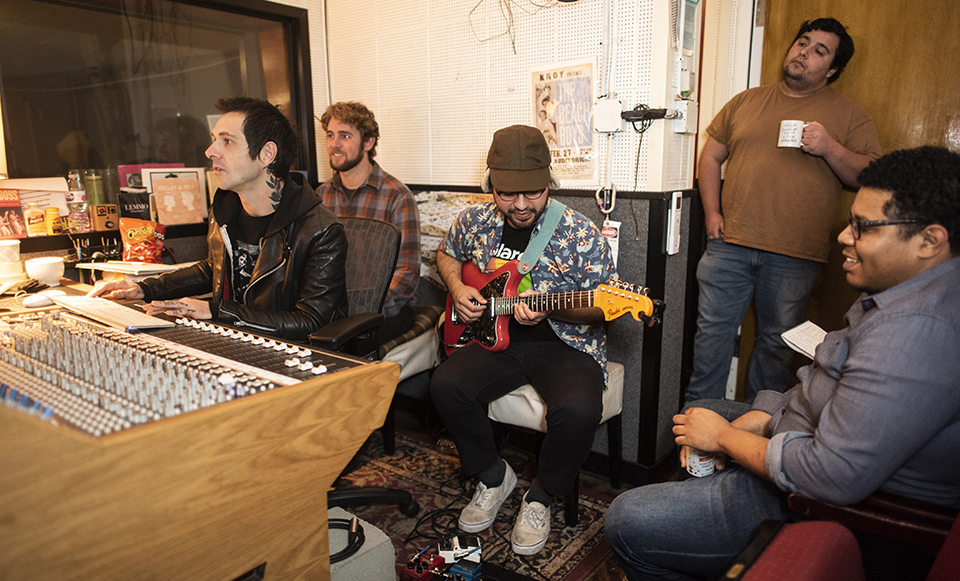 The VOVE students, sound engineer and Tokyo Gold band members recording in the studio.