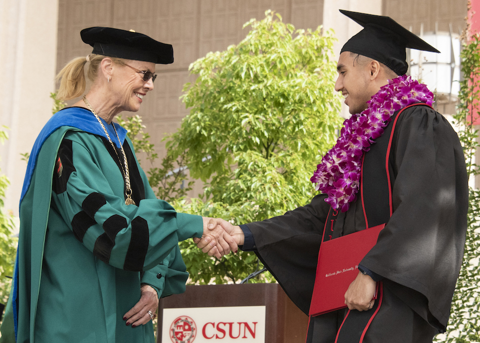 CSUN president shakes graduate's hand